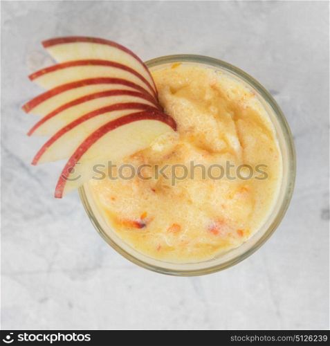 Apple smoothie on a white. Apple smoothie on a white concrete background. Square cropping