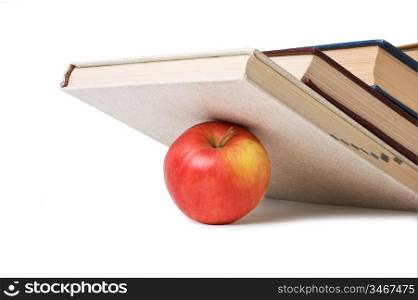 apple under a pile of books isolated on white