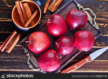 apples and cinnamon on the wooden table