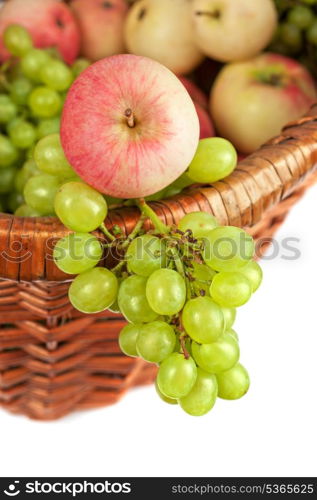 apples and grapes in a basket just harvest