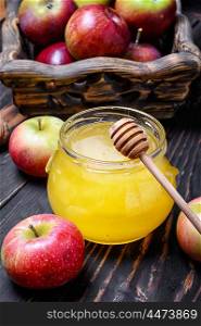 Apples and honey. jar of honey and wooden basket of apples