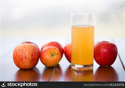 apples and juice on a wooden table, outdoor