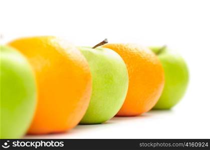 apples and oranges in row isolated on white