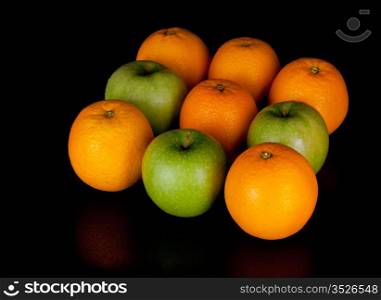 apples and oranges isolated on black