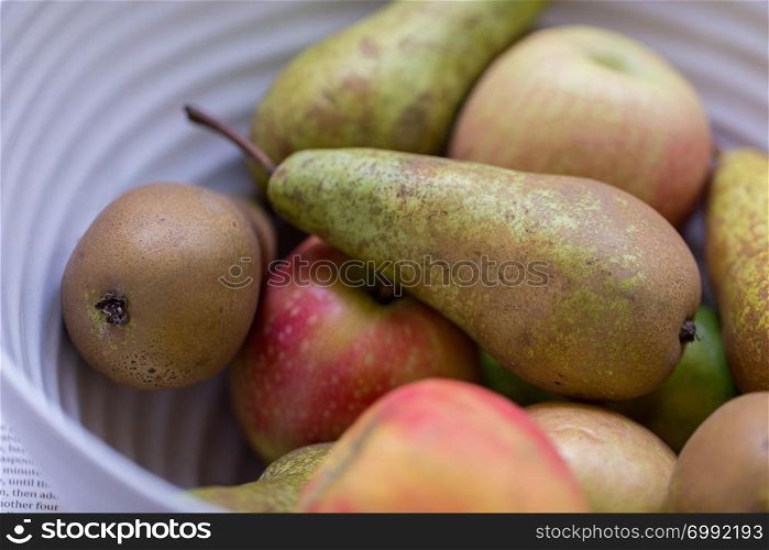 Apples and pear fruit in a bowl