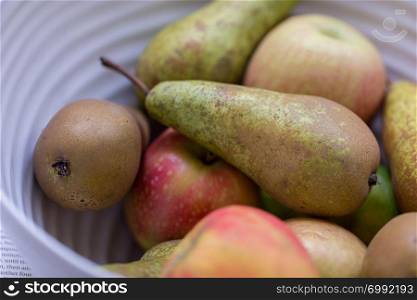 Apples and pear fruit in a bowl