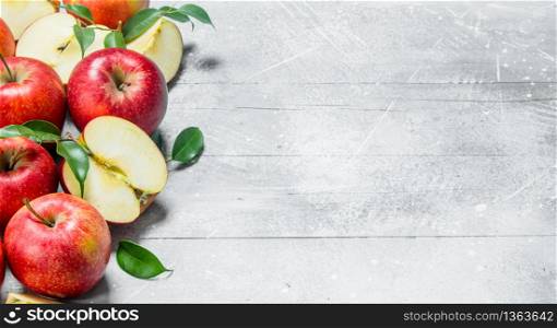 Apples and slices of red apples. On rustic background.. Apples and slices of red apples.