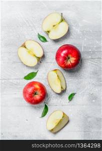 Apples and slices of red apples. On rustic background.. Apples and slices of red apples.