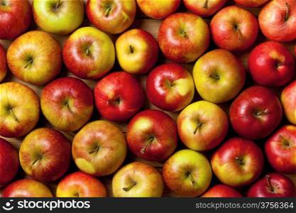 Apples background, fresh fruits on wood table, top view
