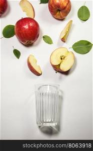 apples for juicing. Fresh apple juice flowing from apple piece into the glass