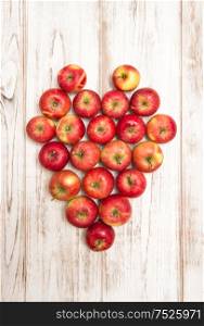 Apples heart over rustic wooden background. Love concept