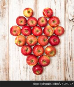 Apples heart over rustic wooden background. Love concept. Vibrant colors