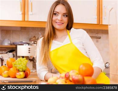 Apples hobby diet salad concept. Female cook working in kitchen. Young lady in apron preparing healthy food out of natural fruits.. Female cook working in kitchen.