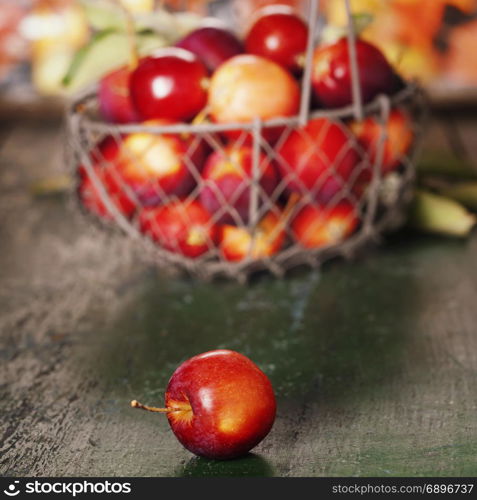 Apples in basket on old wooden background