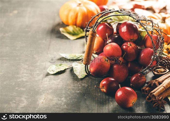 Apples in basket on old wooden background, halloween, harvest, autumn concept