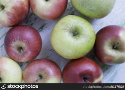 Apples on wooden background. some apples lie on a wooden background. Shooting from the top