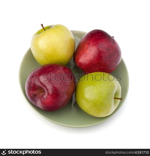 Apples pile on plate isolated on white background