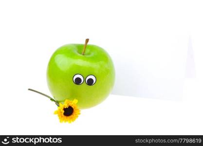 apples with eyes and faces and a flower isolated on white