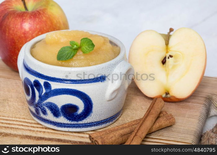 Applesauce with cinnamon in stoneware bowl. Applesauce with cinnamon in stoneware bowl.