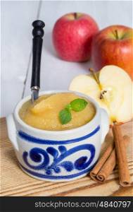 Applesauce with cinnamon in stoneware bowl. Applesauce with cinnamon in stoneware bowl.