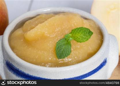 Applesauce with cinnamon in stoneware bowl. Applesauce with cinnamon in stoneware bowl.
