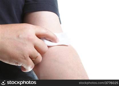 applying a cotton swab to an arm after blood sample