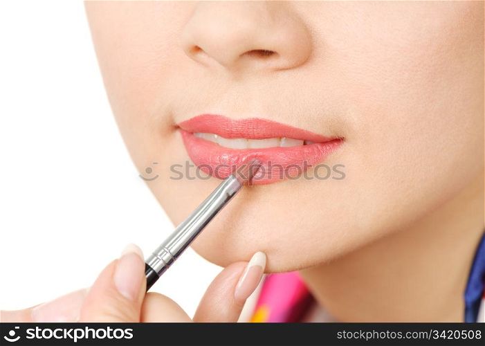 applying liquid glossy lipstick using special brush.