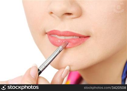 applying liquid glossy lipstick using special brush.