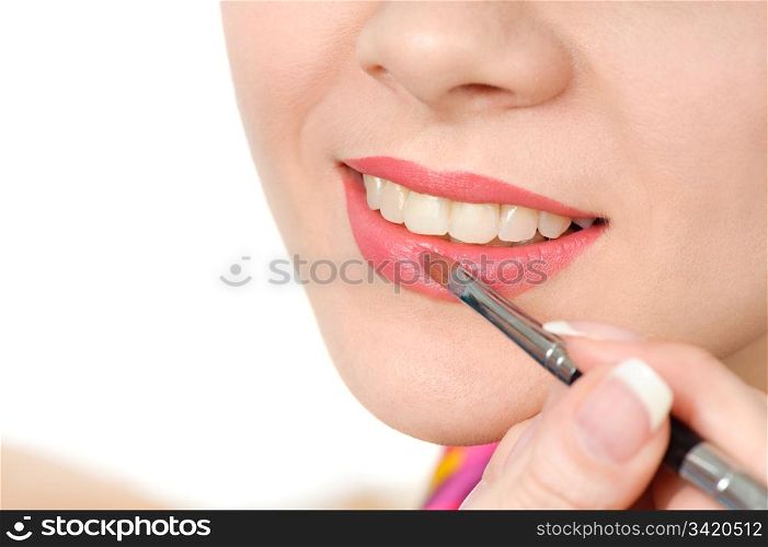 applying liquid glossy lipstick using special brush. applying liquid glossy lipstick