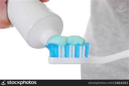 applying Toothpaste to tooth brush isolated over white with copy-space