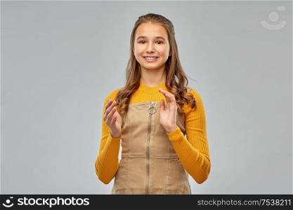appreciation, gratitude and acknowledgment concept - smiling teenage girl applauding over grey background. smiling teenage girl applauding on grey background