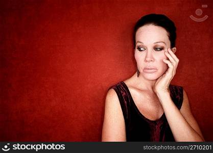 Apprehensive woman on red background