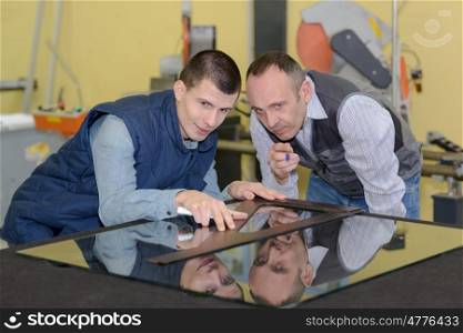 apprentice and teacher glazier in the workshop
