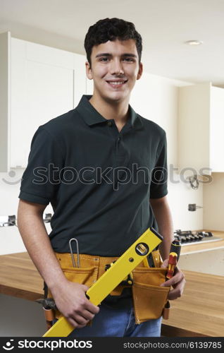 Apprentice Carpenter Installing Luxury Fitted Kitchen