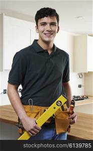 Apprentice Carpenter Installing Luxury Fitted Kitchen