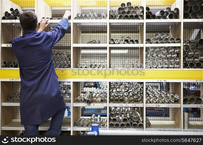 Apprentice Checking Stock Levels In Store Room