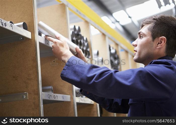 Apprentice Checking Stock Levels In Store Room