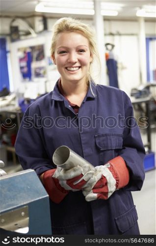 Apprentice Engineer Working On Factory Floor