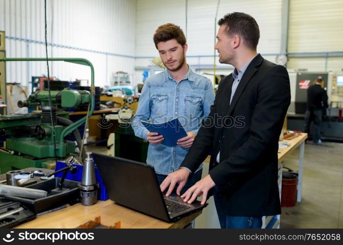 apprentice fixing an engine problem