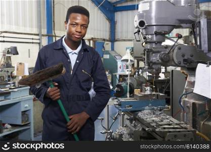 Apprentice In Engineering Factory Sweeping Floor