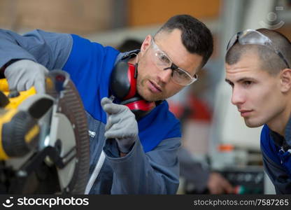 apprentice learning how to use a circular saw