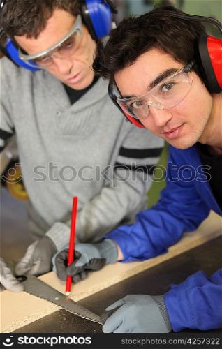 Apprentice marking a piece of wood