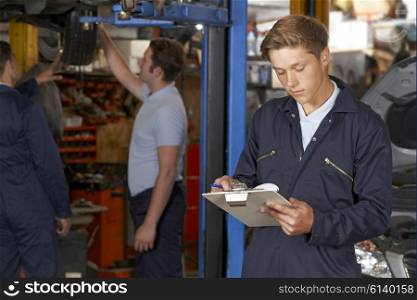 Apprentice Mechanic Working In Auto Repair Shop