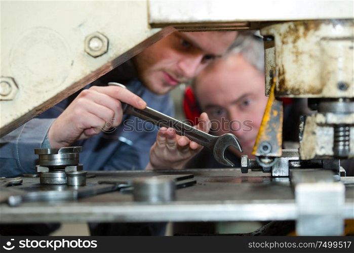 apprentice mechanic working in auto repair shop