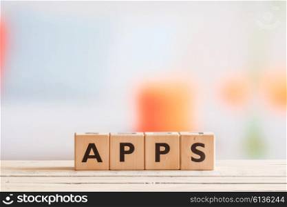 Apps sign on a wooden table in bright light