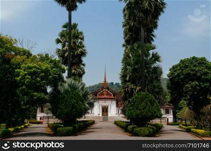 APR 5, 2019 Luang Prabang, Laos - Luang Prabang Royal Palace Museum main building among palm tree in peaceful morning
