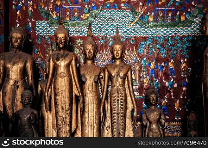 APR 5 Luang Prabang, Laos - Antique old wooden and gold Buddha statues at Wat Xieng thong museum. Most Famous tourist attraction in World heritage zone