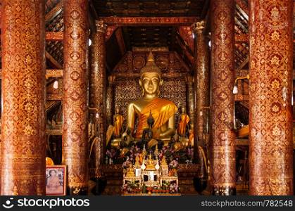 APR 5 Luang Prabang, Laos -Beautiful old golden Buddha statue hall with mural art painting at Wat Xieng thong,