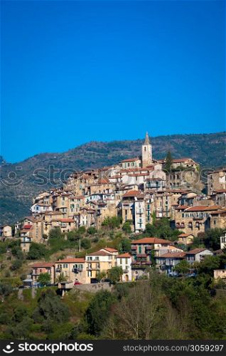 APRICALE, ITALY - CIRCA AUGUST 2020: traditional old village made of stones located in Italian Liguria region with blue sky and copyspace