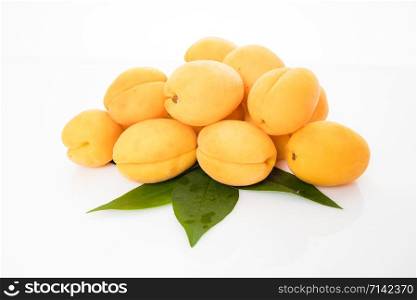 Apricot fruit with leaf isolated on white background
